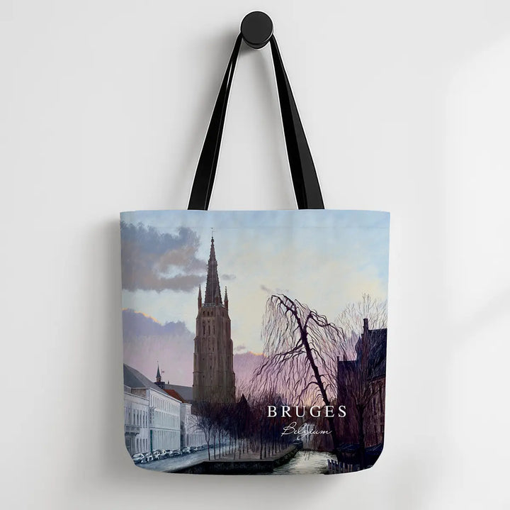 Tote bag with a scenic design of Bruges featuring a tall tower and canal.