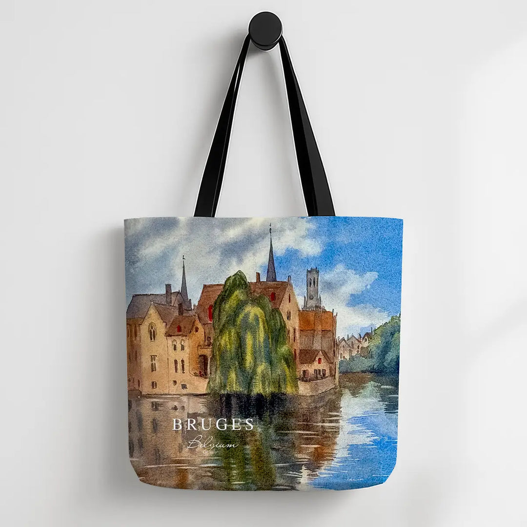Tote bag with a scenic design of Bruges, featuring buildings and water.