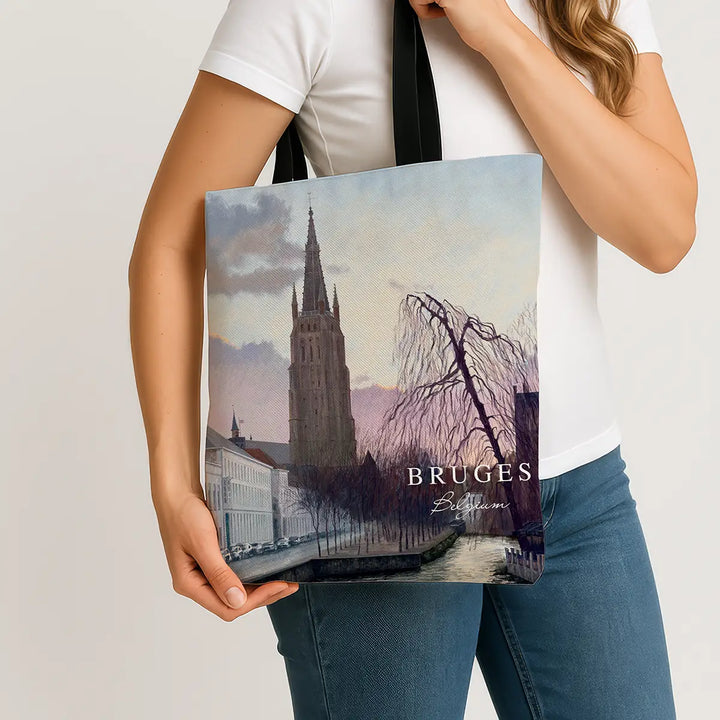 Person holding a tote bag with Bruges design