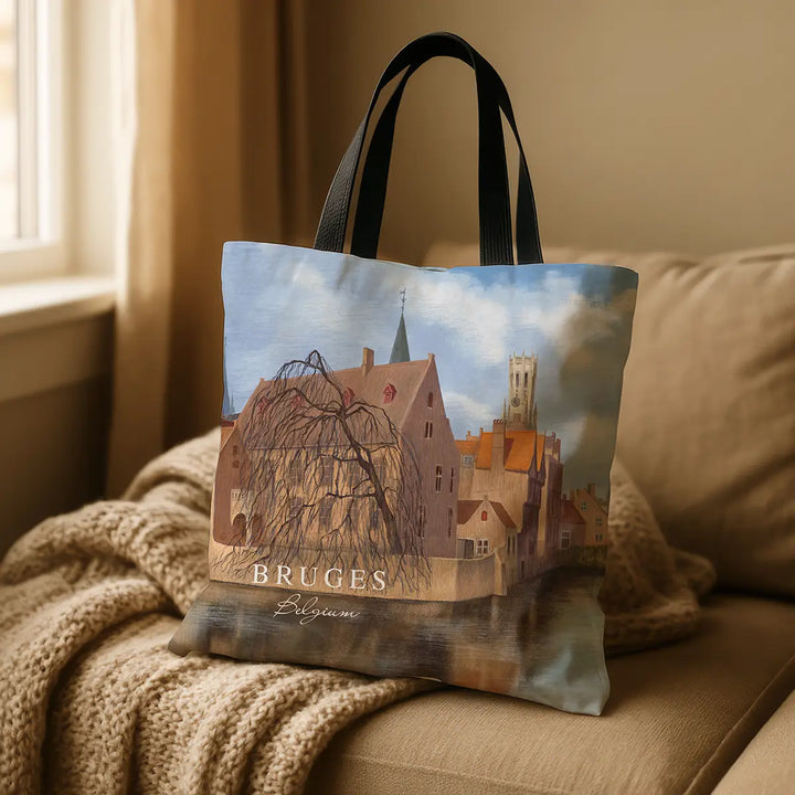 Tote bag with a scenic design of Bruges on a couch