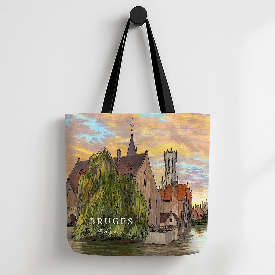 Tote bag with a scenic design of Bruges, featuring buildings and a river.