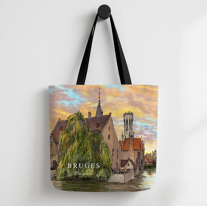 Tote bag with a scenic design of Bruges, featuring buildings and a river.